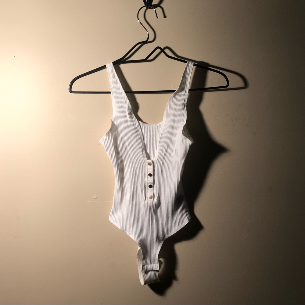 Low cut leotard with gold buttons